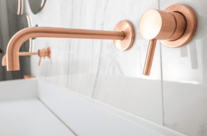 A modern bathroom faucet in copper.