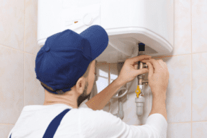 man working on a water heater