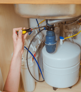 An under-sink water filtration system is shown