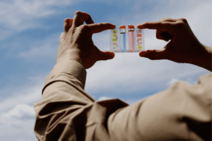 Hands hold a water quality test kit